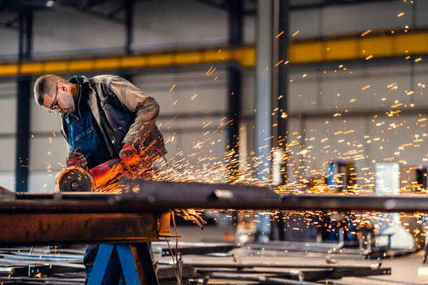 istock Factory worker cutting metal with grinder. 1210678710
