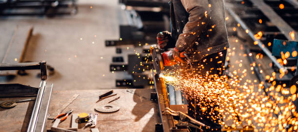 istock Factory worker cutting metal with grinder. 1210678736