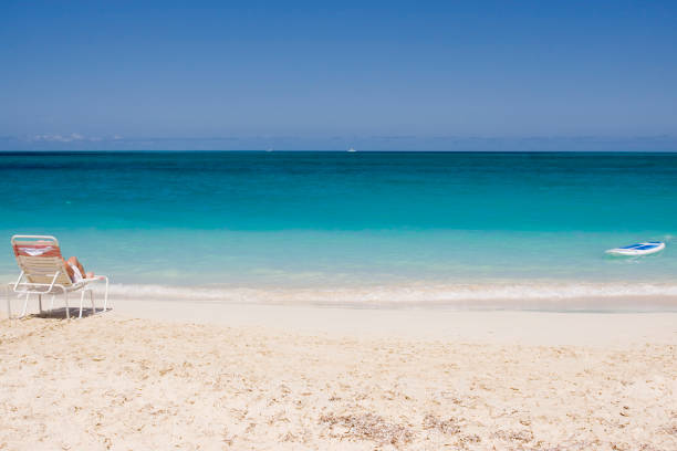 Grace Bay beach in Turks and Caicos Islands with a beach chair and stand up paddleboard