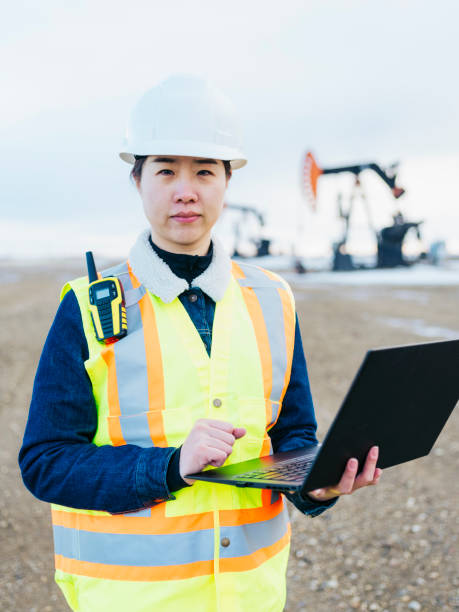 istock Female Oil Worker using laptop 1210680790