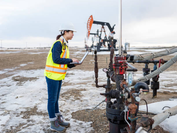 istock Female Oil Worker using laptop 1210680825