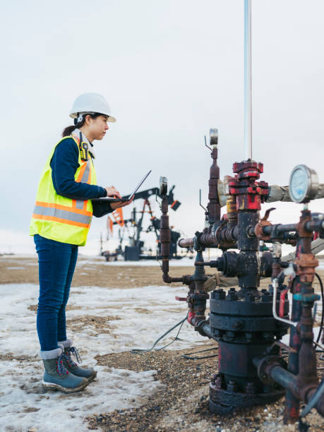 istock Female Oil Worker using laptop 1210680827