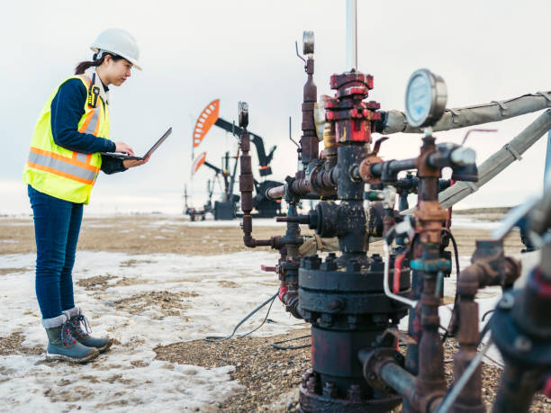 istock Female Oil Worker using laptop 1210681381