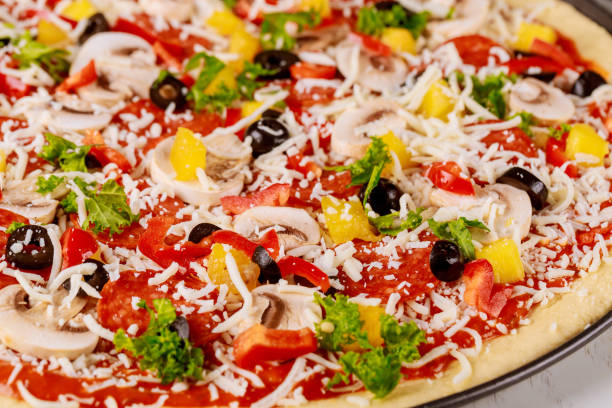 istock Raw pizza with mushroom, pepperoni and pineapple. 1210682787