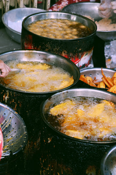 istock boiling oil pan on charcoal stove, crispy snacks cake powder 1210686750