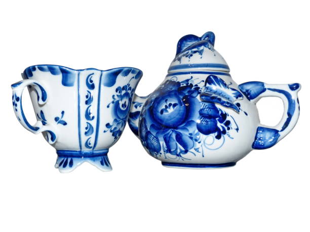 istock Teapot and Cups isolated on a white background. Home tableware in Russian traditional Gzhel style. Gzhel - Russian folk craft of ceramics and production porcelain 1210696422