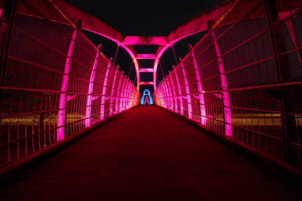 istock Bright red LEDs illuminate pedestrian walkway over highway at night 1210704814