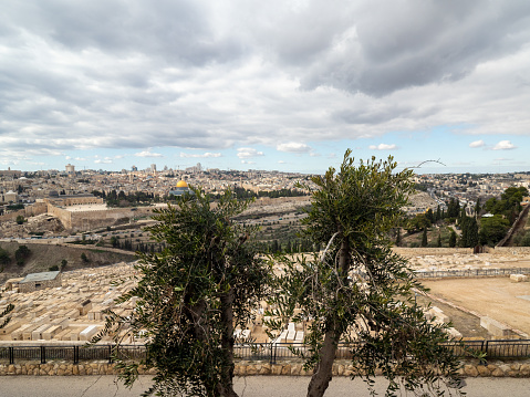 Jerusalem/Israel - December 27 2019: Mount of Olives Jewish Cemetery. This is the most ancient and most important Jewish cemetery in Jerusalem. The Old City panorama seen in the distance