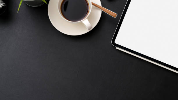 istock Top view of workplace with mock-up tablet, coffee cup and copy space 1210707741