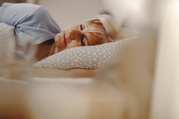 istock Senior woman resting while sleeping in the bed. 1210709031