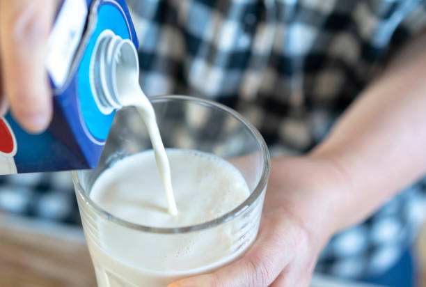 istock pouring milk into glass 1210710270