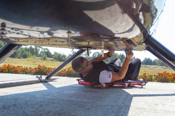 istock Man on the cart cleaning under the helicopter 1210712837