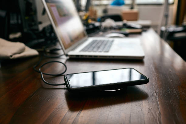 istock The smartphone charging wirelessly is on the desk，Charge sharing concept 1210714505
