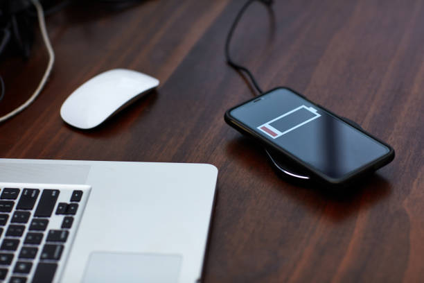 istock The smartphone charging wirelessly is on the desk，Charge sharing concept 1210714610