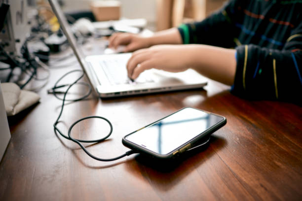 istock The smartphone charging wirelessly is on the desk，Charge sharing concept 1210714652