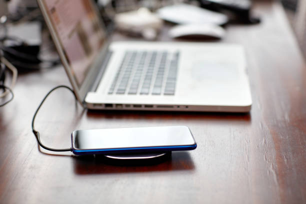 istock The smartphone charging wirelessly is on the desk，Charge sharing concept 1210714766
