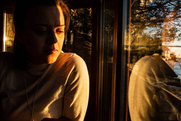 istock Woman looking down through the window 1210716069
