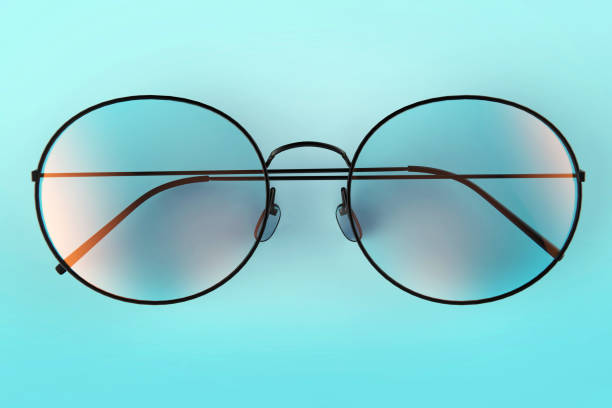 istock Glasses isolated on blue stock photo 1210716238