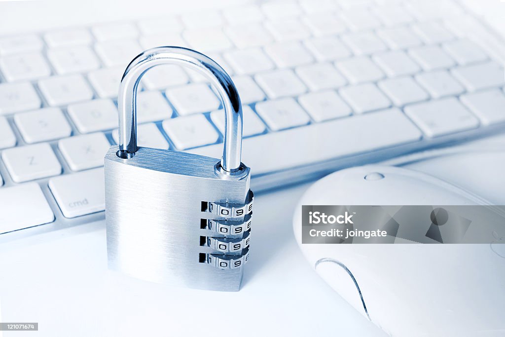 White Apple keyboard and mouse, with metal combination lock idea for computer and online security with keyboard and padlock Agreement Stock Photo