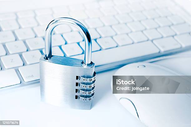 White Apple Keyboard And Mouse With Metal Combination Lock Stock Photo - Download Image Now