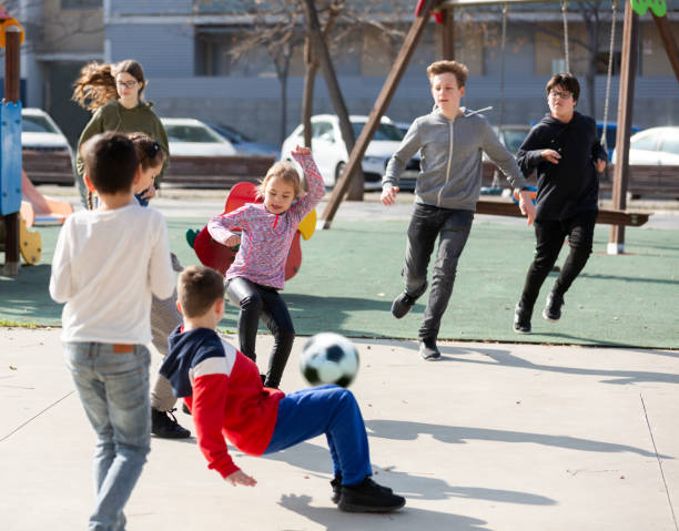 istock Children playing soccer with ball 1210717257