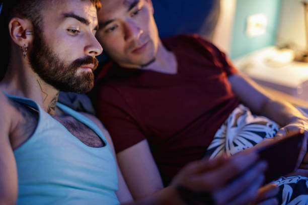 istock Homosexual couple using smart phone 1210721555