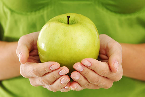 istock apple in woman hands 121072166