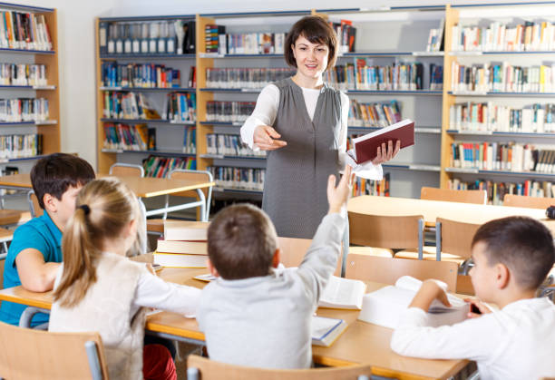 istock Female teacher working with pupils 1210721981