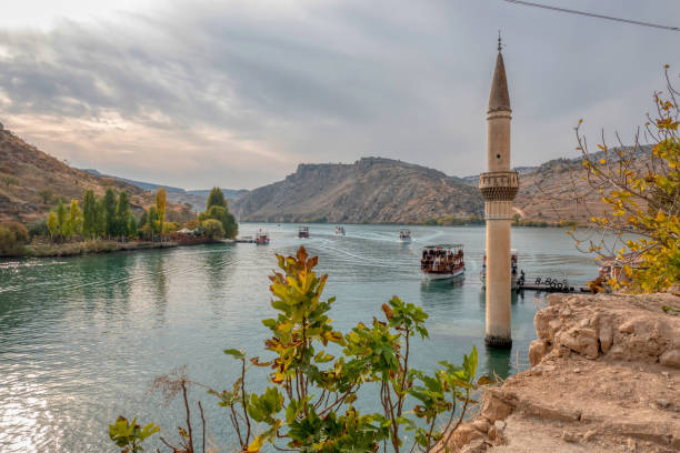 Minaret of the mosque in the water of the dam Minaret of the mosque in the water of the dam halfeti stock pictures, royalty-free photos & images