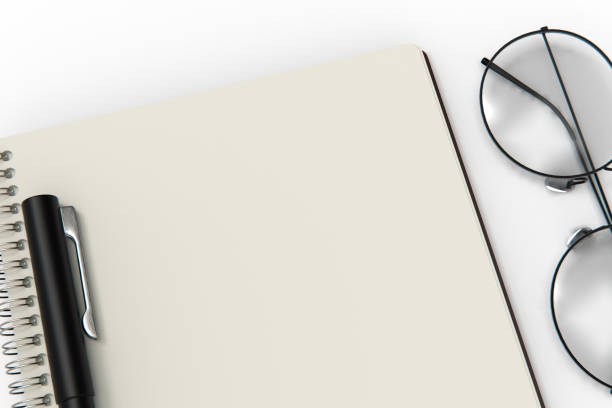 istock A notebook and glasses isolated on white background. stock photo 1210726359