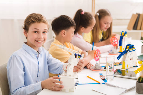istock Stem education. Smiling schoolboy showing his robot 1210728621