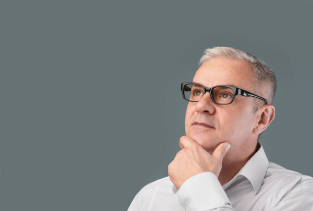 istock Mature pensive man portrait on gray background 1210729707