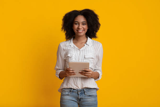 istock Millennial Afro Woman With Digital Tablet In Hands Smiling At Camera 1210729873