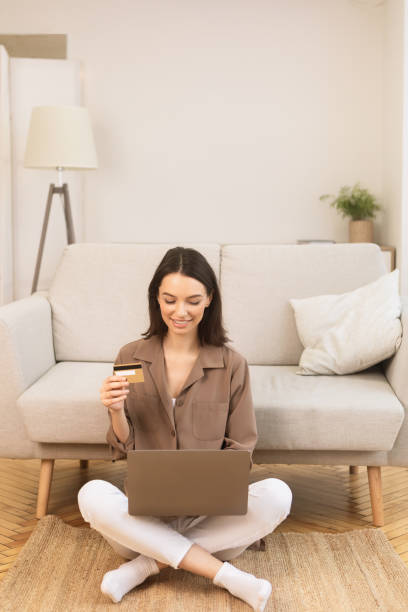 istock Girl making purchases sitting on the carpet 1210730818