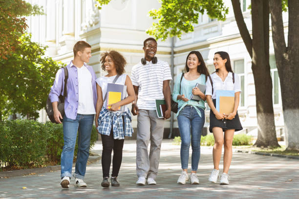 istock Happy university students walking together on campus, chatting and laughing outdoors 1210731296