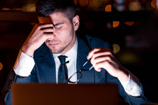 istock Businessman Having Headache Tired Of Work In Office At Night 1210732238