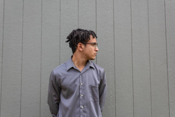 istock Black male with short dreads in profile view, ample copy space over neutral background 1210732389