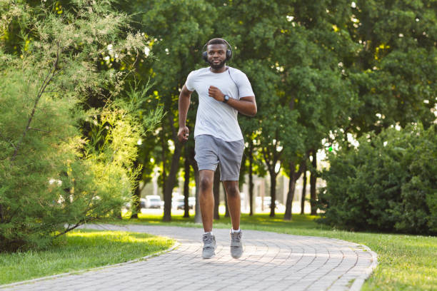 istock Athletic black guy exercising in public park 1210733548