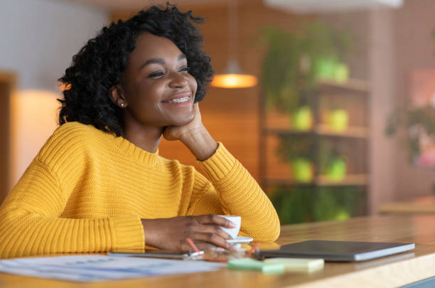istock Excited afro girl dreaming about prosperous future, drinking tea 1210735869