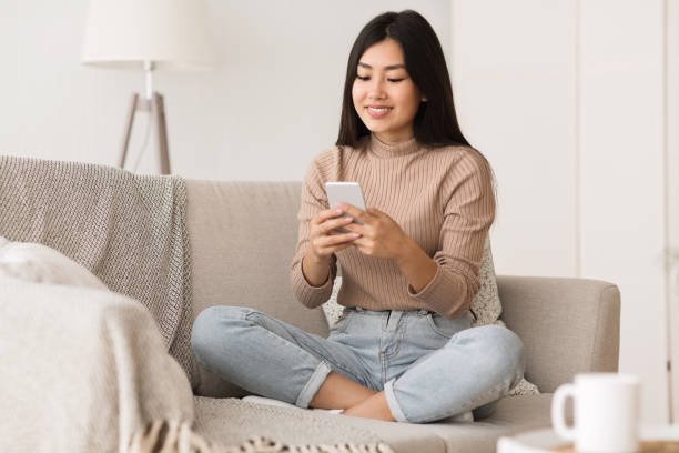 istock Cheerful girl texting on smartphone, enjoying weekend 1210736258