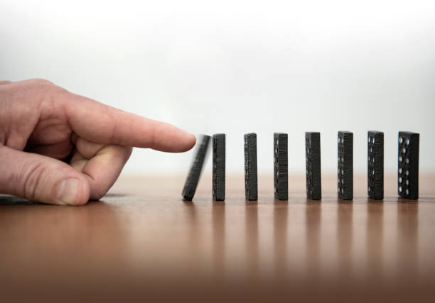 istock dominoes are knocked over with one finger 1210736698
