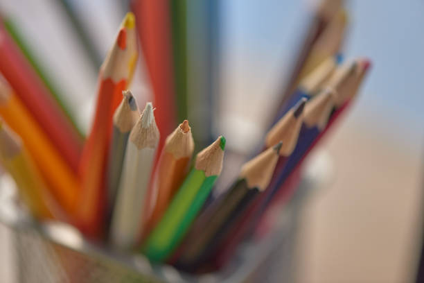 Defocused shot of a set of colored pencils in an office environment