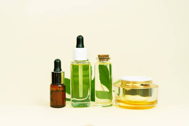 istock Various glass bottles with herbal CBD oil, THC tincture and hemp leaf on pastel beige background. 1210737968