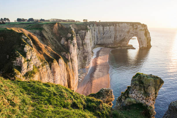 istock Beautiful cliffs at Etretat at sunset, Normandy coast, France 1210738025