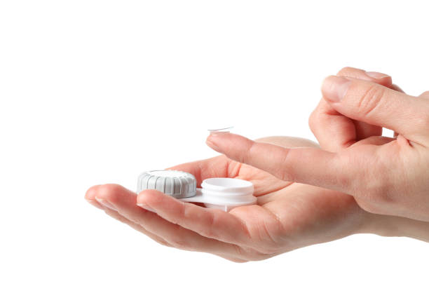 istock Hands with contact lens and case isolated on white background 1210738221