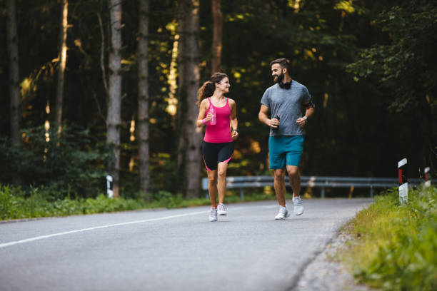 istock Young couple jogging in nature 1210738289