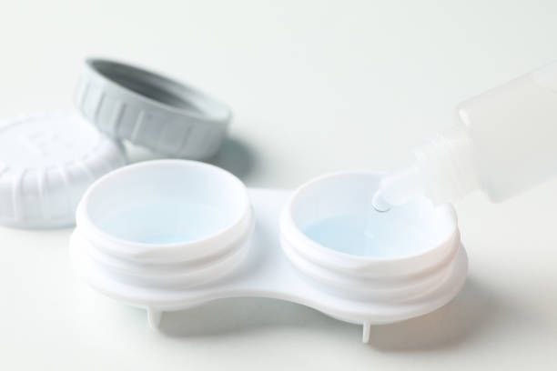 istock Contact lenses and liquid on white background, close up 1210738748
