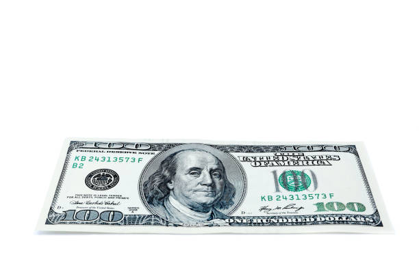 istock hundred dollars isolated on white close up look 1210739393