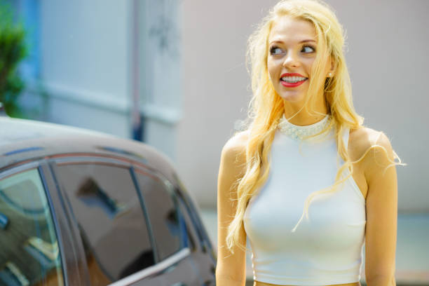 istock Funny elegant woman and car 1210739583