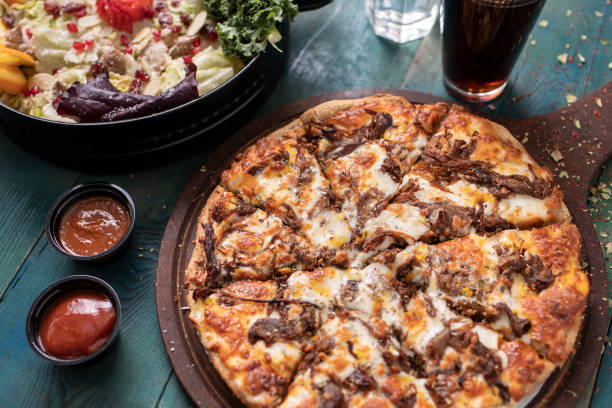istock Roast beef pizza with colorful green salad 1210739596